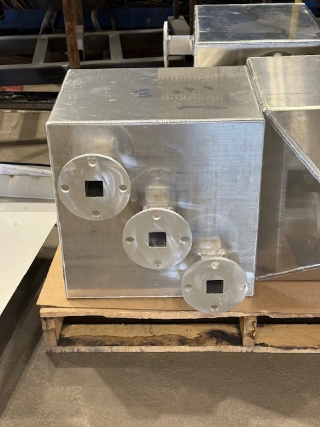 Production CAST unit — three inline flanges with square openings on the process face